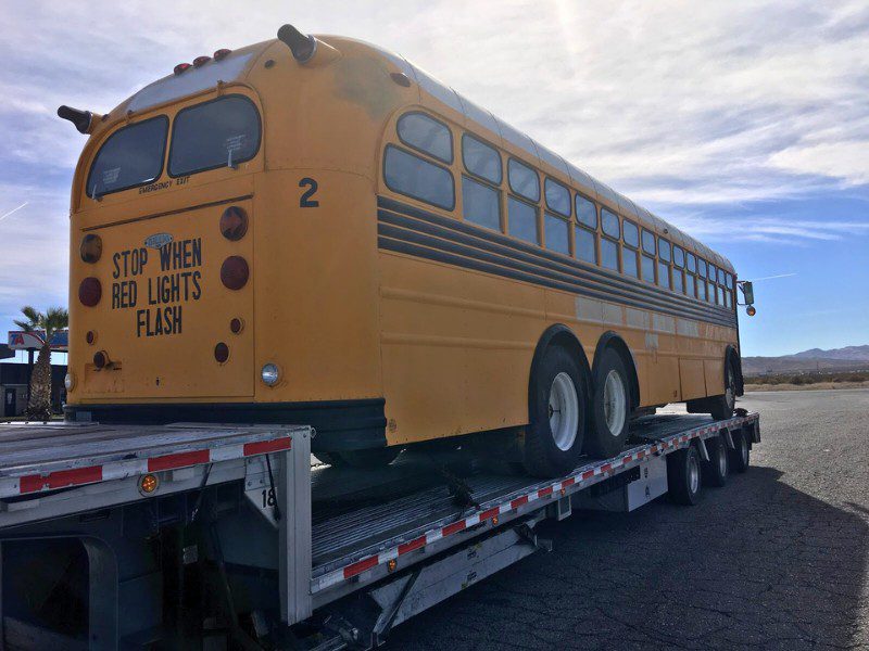 shipping a bus: a school bus hauled on a stepdeck trailer